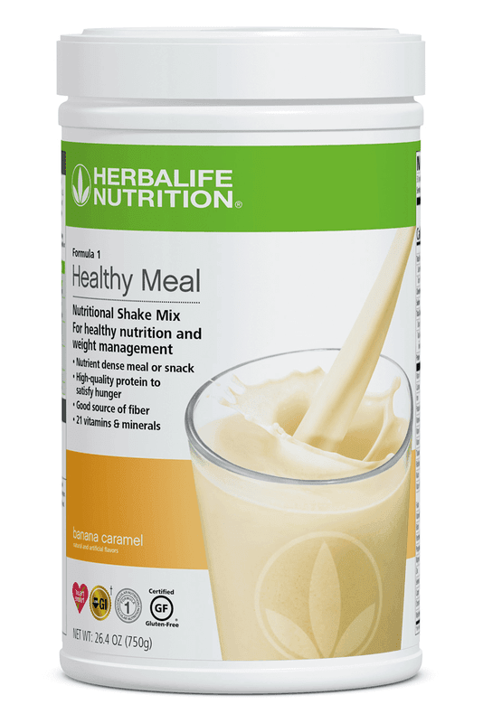 Formula 1 Healthy Meal Nutritional Shake Mix Banana Caramel flavor in a container with a glass of shake.